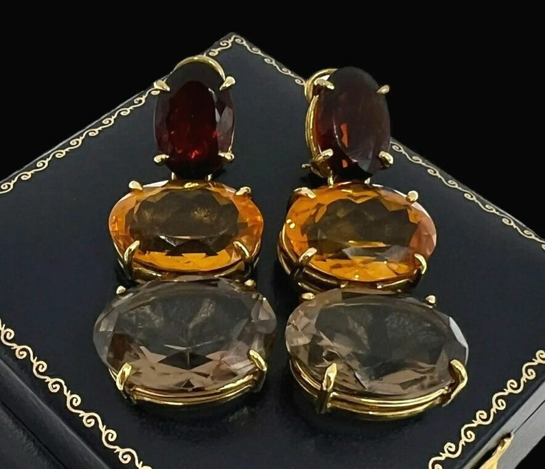 Sold. Pair of 14K Yellow Gold Dangle style Garnet, Citrine and Smokey Quartz Gemstone Pierced Earrings. Weighing 27.30 grams